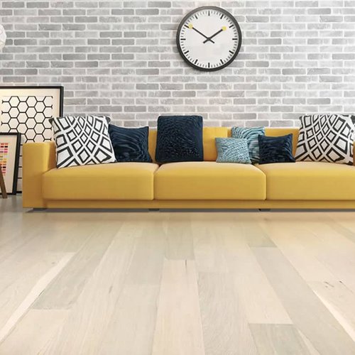 deep seated yellow sofa with bright color pillows